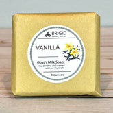 Vanilla Goat milk soap bar with vanilla scent from Brigid Trading Company on a wooden surface.