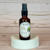 pipe smoke room and linen spray Brown spray bottle labeled 'Pipe Smoke' by Brigid on a wooden surface.