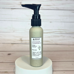 Bottle of Brigid Lavender Chamomile body lotion on a wooden surface eco friendly packaging wheat straw recyclable biodegradable natural lotion 2 ounce tsa friendly travel size