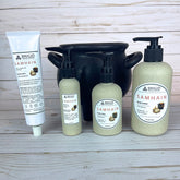 Collection of Brigid Samhain natural hand and body lotion products on a wooden surface in front of a black cauldron