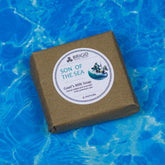 goats milk soap natural by brigid trading company son of the sea scent hand milled sea salt ocean sprau saddle leather image shows a bar of soap on a nautical background of waves kitsap county washington state