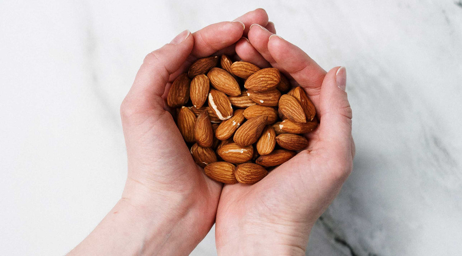 sweet almond oil hands with almonds used with permission pexels photo by cottonbro studio