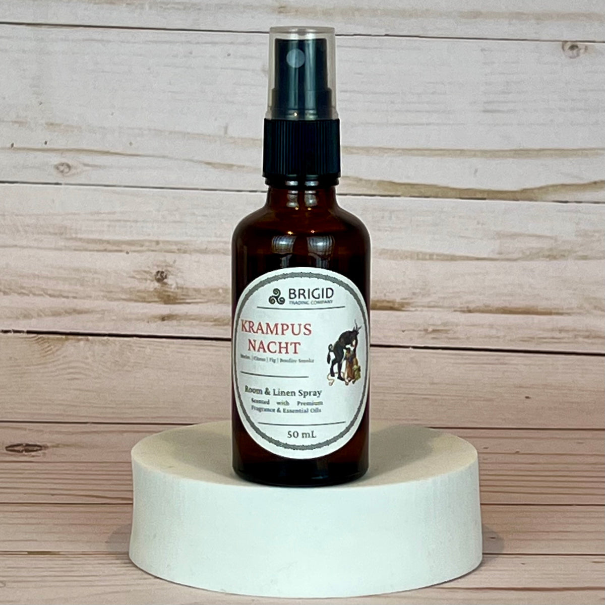 krampusnacht room and linen spray Brown spray bottle labeled 'Brigid Krampus Nacht' on a wooden background