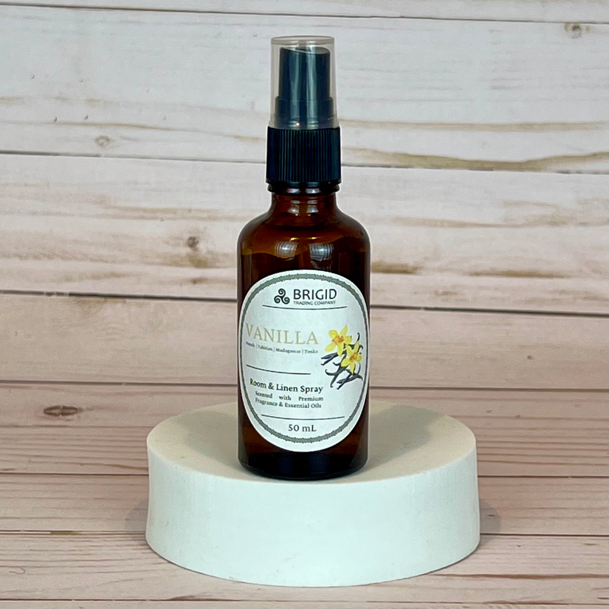 vanilla room and linen spray brigid Vanilla air and linen spray bottle on a wooden background