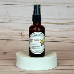 mabon room and linen spray Brown spray bottle labeled 'Mabon' on a white pedestal with wooden background