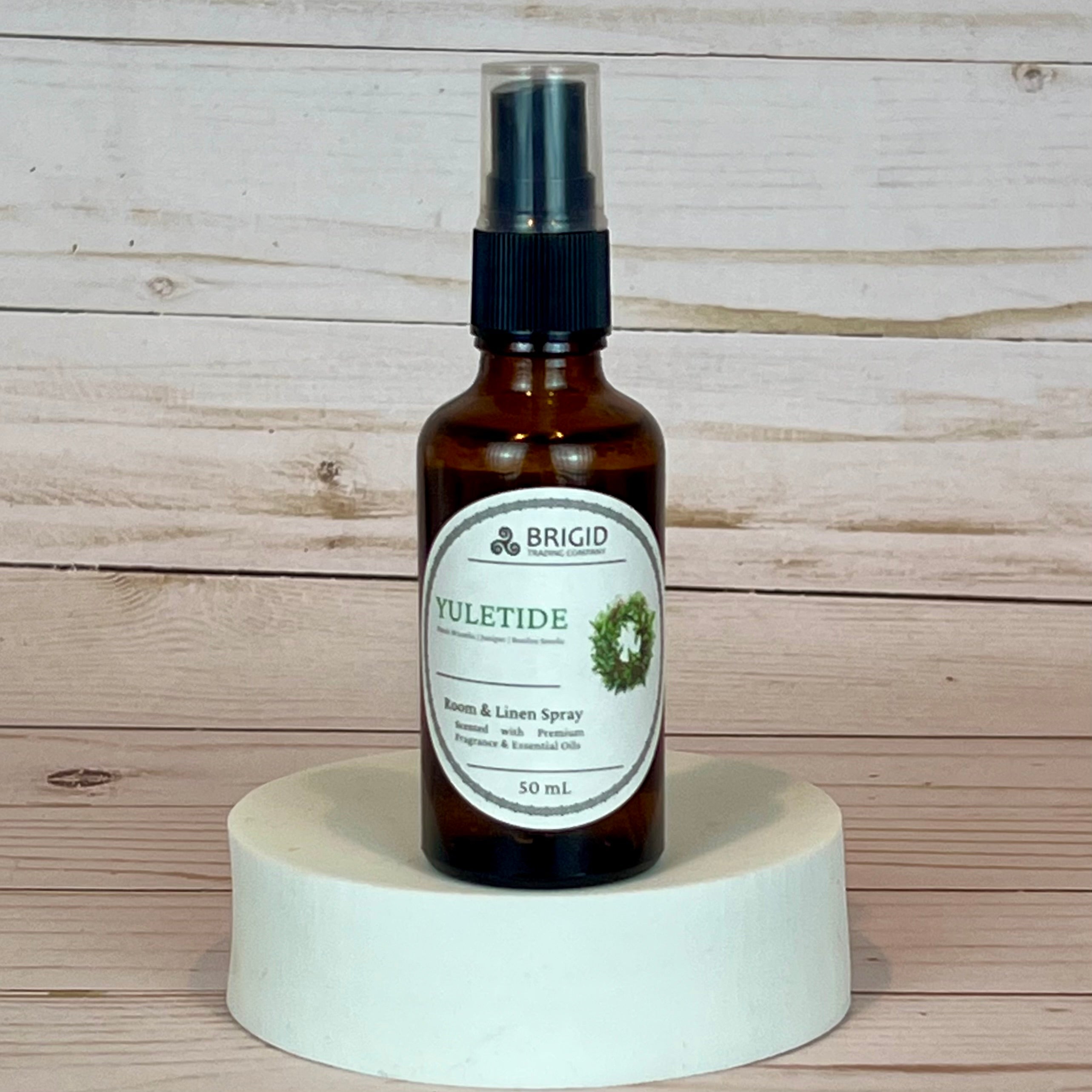 yuletide room and linen spray Bottle of Brigid Yuletide Room & Linen Spray on a wooden background