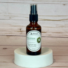 yuletide room and linen spray Bottle of Brigid Yuletide Room & Linen Spray on a wooden background