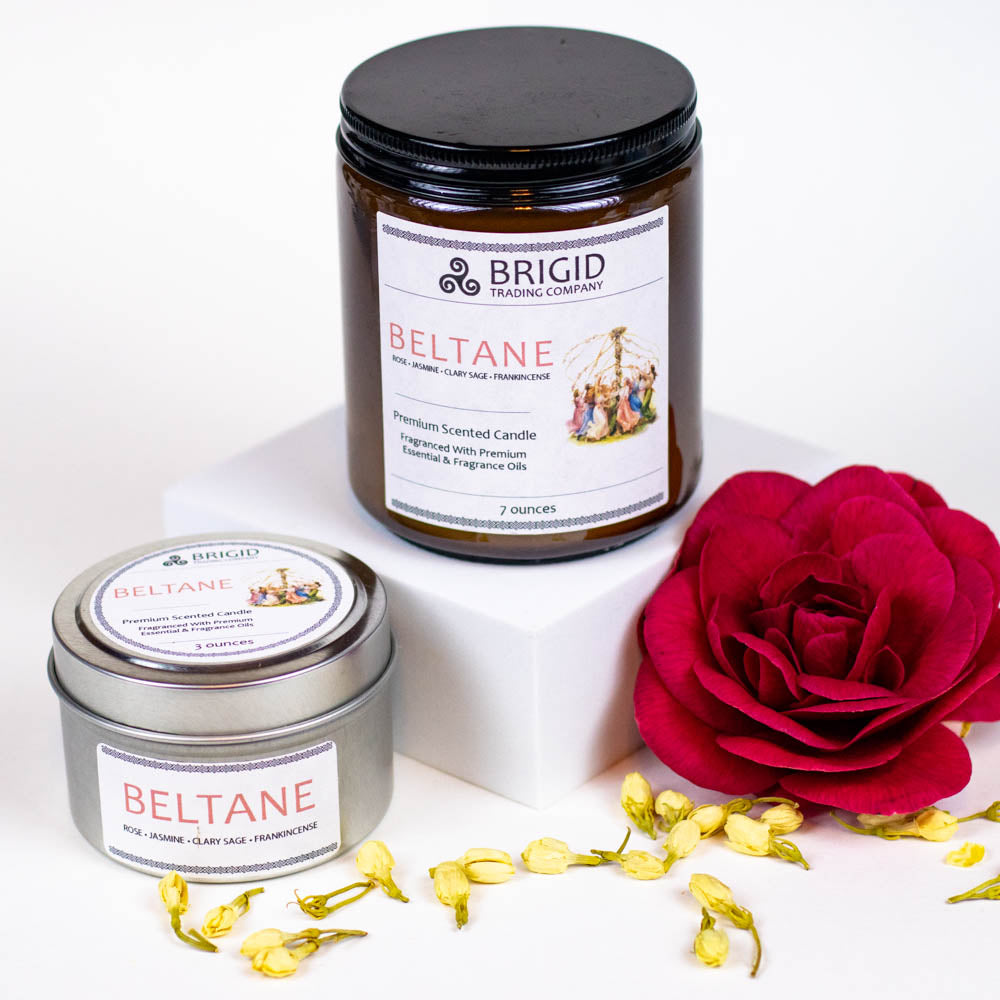 beltane soy wax candle jasmine clary sage and frankincense hand made natural celtic inspired made in kitsap county washington state image shows a white background with a red flower and jasmine flowers two candles one in a large 7 ounce glass jar and one in a small 3 ounce travel container tin with the lid on