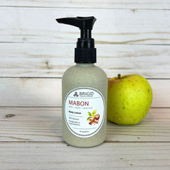 mabon body lotion 4 ounce four in eco pump bottles wheat straw black tops natural hand mixed harvest moon festival gifts for mom girlfriend pagan christian catholic presents for fall autumn apples apple cinnamon apple pie scented fresh apples harvest spices image of bottles on wooden backdrop with fresh green and red apple