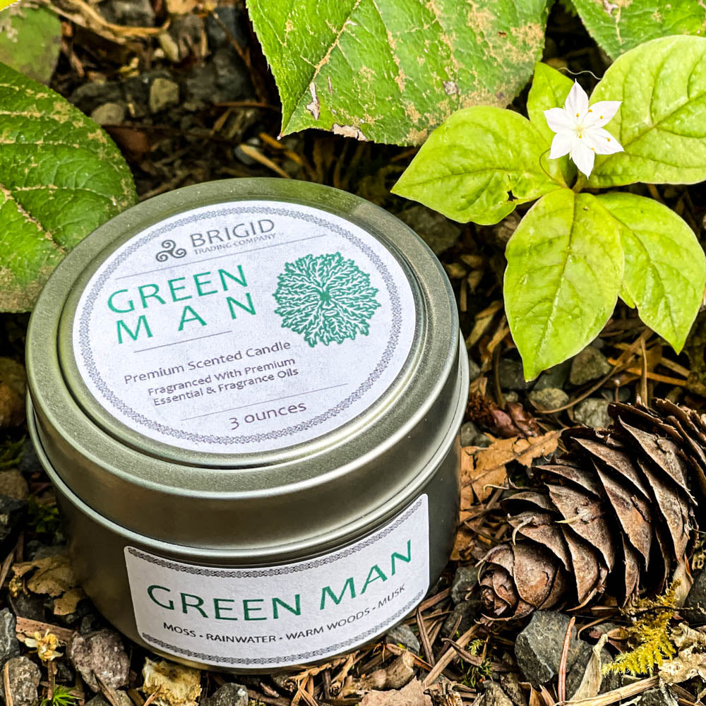 green man candles 3oz outside shoot tin small size original rainforest fresh scent with moss rainwater warm woods and musk celtic candles soy wax premium made in washington state hand made shown with western star flower