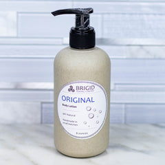 original body lotion by brigid trading company unscented fragrance free sensitive skin skincare all natural organic hand made in washington state dye free scent free nonscented goat's milk shea butter lotion body lotion self care package original studio photography by brigid trading company bremerton washington state white tile countertop image with product photographs