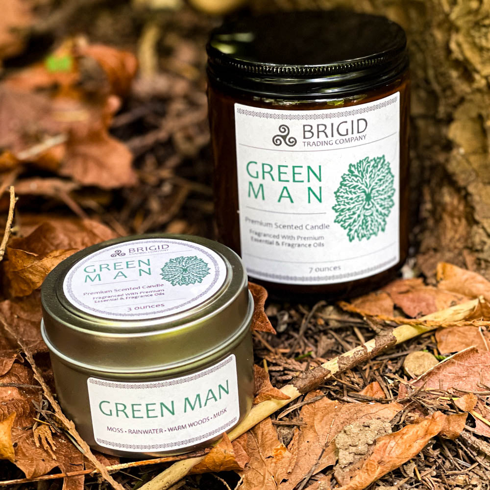 green man candles 7oz and 3oz outside shoot glass jar and tin two sizes original rainforest fresh scent with moss rainwater warm woods and musk celtic candles soy wax premium made in washington state hand made shown on forest floor