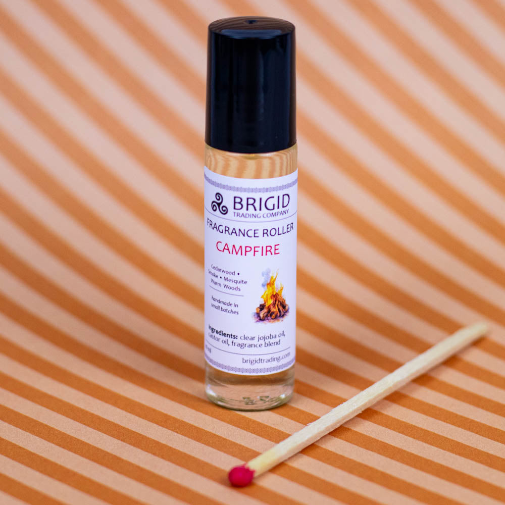 brigid trading company fragrance roller image studio photography by brigid trading company 2024 glass clear bottle with metal ball roller for perfume fragrance essential oil roller ball hand made by brigid trading company kitsap county washington state pacific northwest campfire scent cedarwood mesquite smoke and warm woods