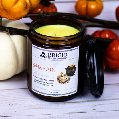 samhain premium soy wax candle celtic spirituality premium scented candles from brigid trading company llc dragons blood resin merlot spices patchouli scent candles large and small handmade in washington state kitsap county 7 ounce candle in glass jar with tiny decorative pumpkins in background