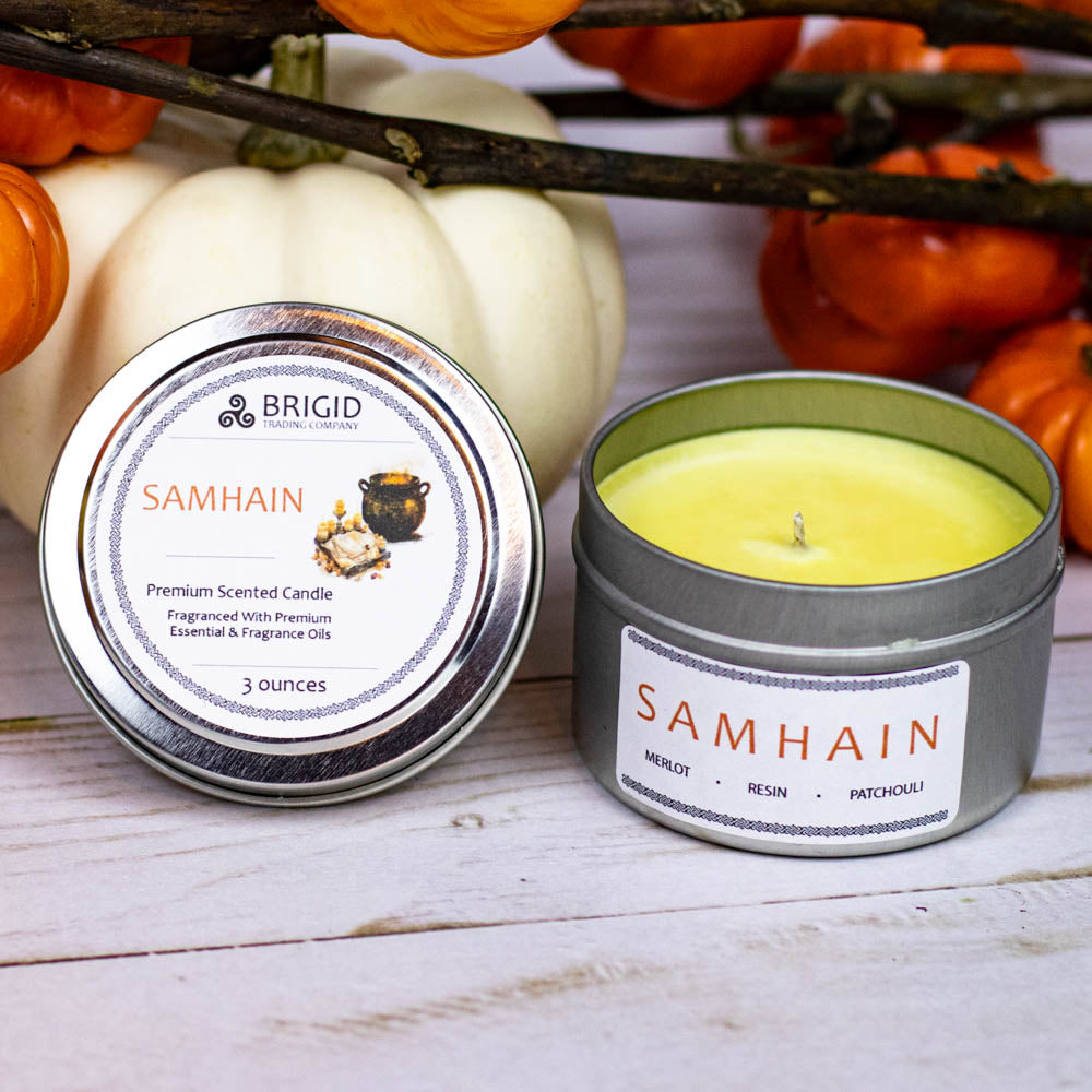 samhain premium soy wax candle celtic spirituality premium scented candles from brigid trading company llc dragons blood resin merlot spices patchouli scent candles large and small handmade in washington state kitsap county 3 ounce candle in small metal tin with tiny pumpkins in background