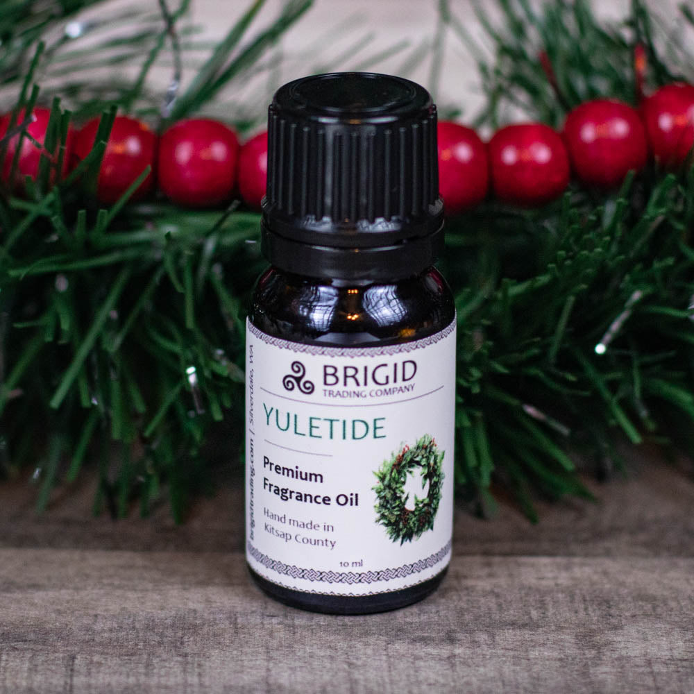 yule yuletide celtic wheel of the year premium fragrance oil diffuser christmas scents tree holidays winter 2025 red beads and holly pine details wooden floor hand made fragrances by brigid trading company llc made in kitsap county washington state