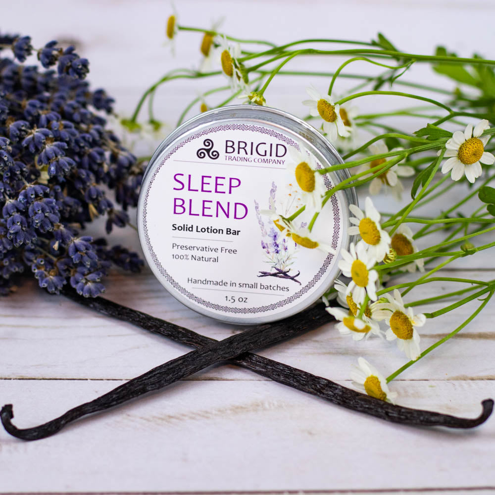 sleep blend solid lotion bar preservative free by brigid trading company lavender chamomile vanilla in background props made with essential oils only no irritants sensitive skin natural skincare