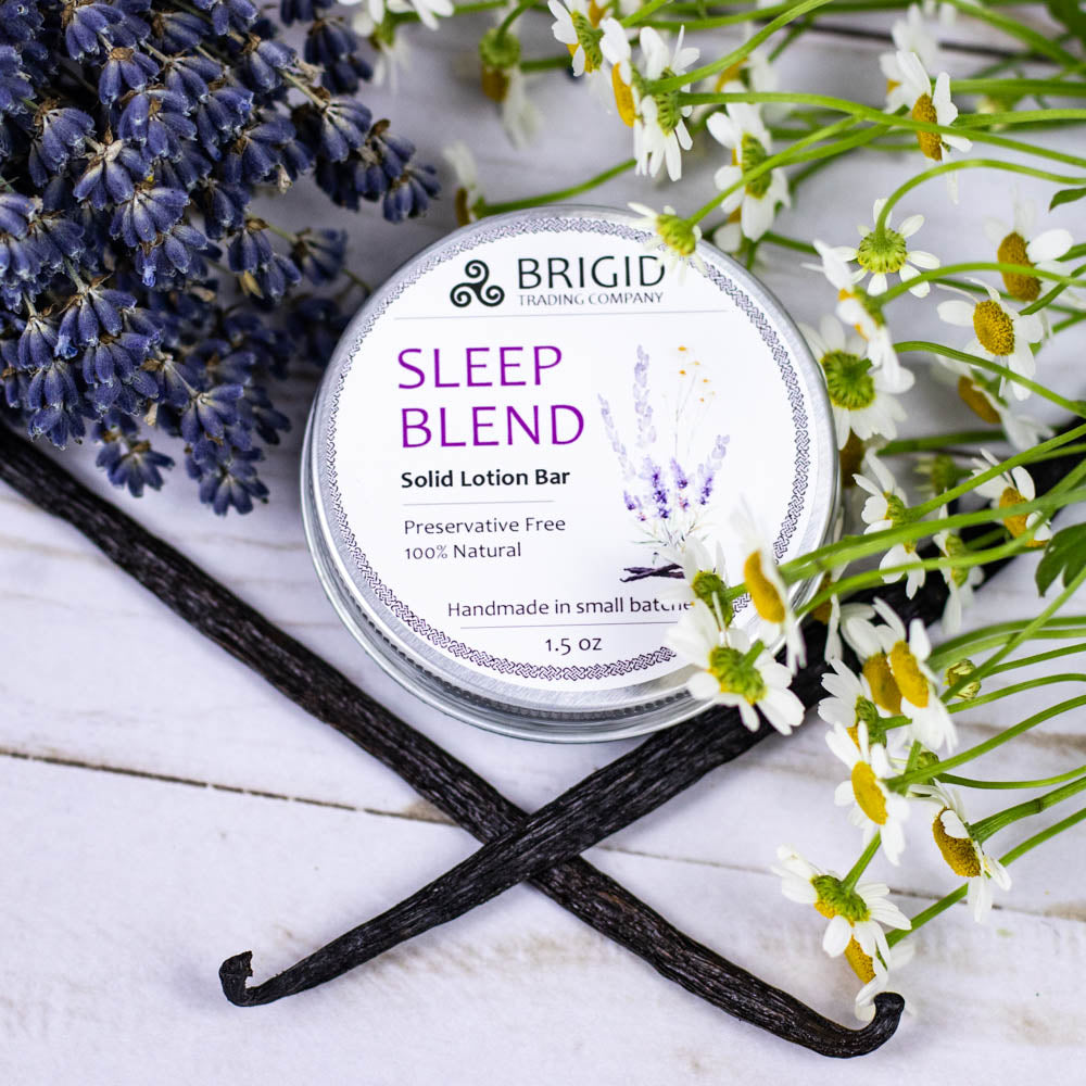 sleep blend solid lotion bar preservative free by brigid trading company lavender chamomile vanilla in background props made with essential oils only no irritants sensitive skin natural skincare