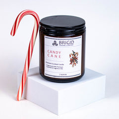 candy cane candle scent by brigid trading company christmas xmas yule yuletide irish christmas inspiration peppermint essential oil and peppermint candy cane fragrance oils the holidays holiday winter winter scent fresh santa claus gifts stocking stuffers small gifts for him for her gifts for mom dad sister brother cousin hard to find presents picky gift giving made in kitsap county washington state united states independent woman owned company 7 ounce glass jar candle shown on white background studio