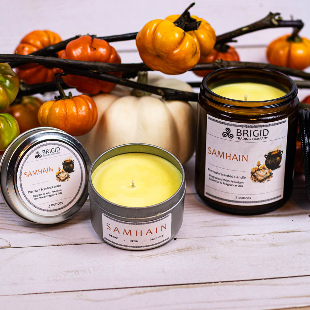 samhain premium soy wax candle celtic spirituality premium scented candles from brigid trading company llc dragons blood resin merlot spices patchouli scent candles large and small handmade in washington state kitsap county tiny pumpkins in background showing yellow wax from resin essential oils and fragrance oils