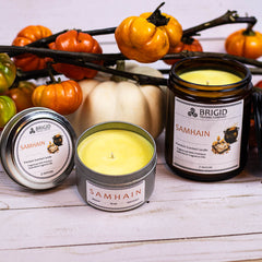 samhain premium soy wax candle celtic spirituality gifts Halloween 2025 premium scented candles from brigid trading company llc dragons blood resin merlot spices patchouli scent candles large and small handmade in washington state kitsap county tiny pumpkins in background showing yellow wax from resin essential oils and fragrance oils