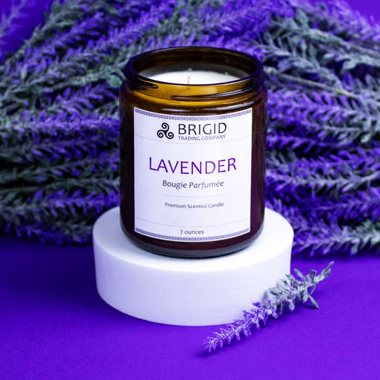 lavender candle bougie parfumee hand poured soy wax candle with natural ingredients studio shot of candle with lavender flowers and purple background on riser by brigid trading company kitsap county washington state united states