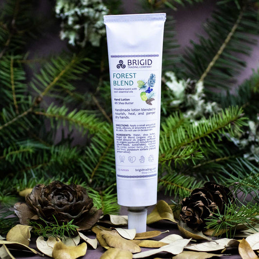 forest blend hand lotion by brigid trading company with forest background pinecones leaves pine brances lychen brown background studio shot