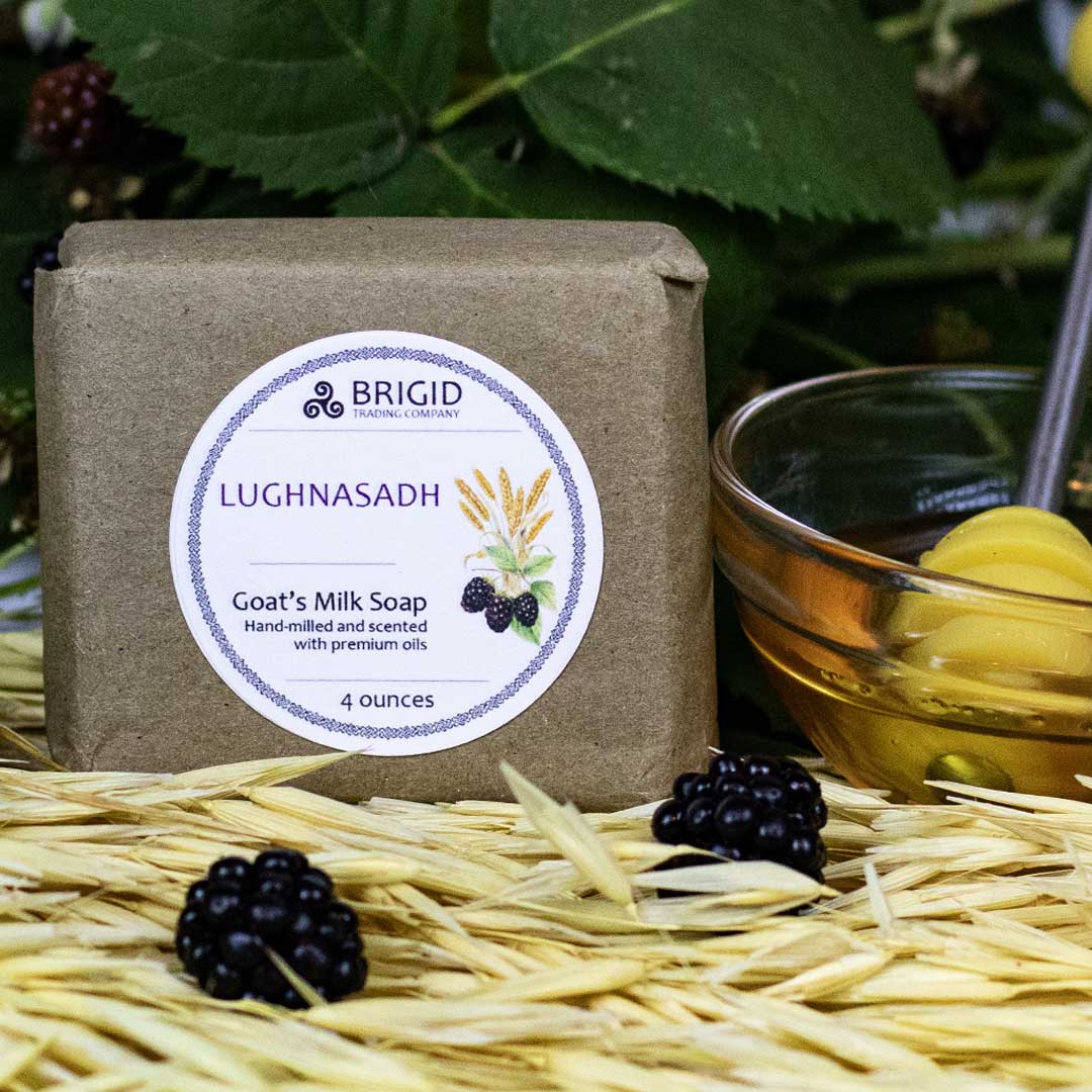 goats milk soap natural by brigid trading company lughnasadh scent hand milled blackberry oat meal honey image shows dried wheat and fresh blackberries with honey bowl detail blackberry leaves oat on stock detail with honey spoon beside soap kitsap county washington state