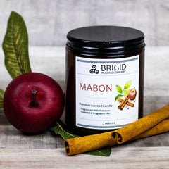 mabon fall scent apple cinnamon and spices thanksgiving fall natural soy wax candles hand made washington state by hand real people independent business essential oil natural organic image shows wood background with red apple and one seven 7 ounce candle