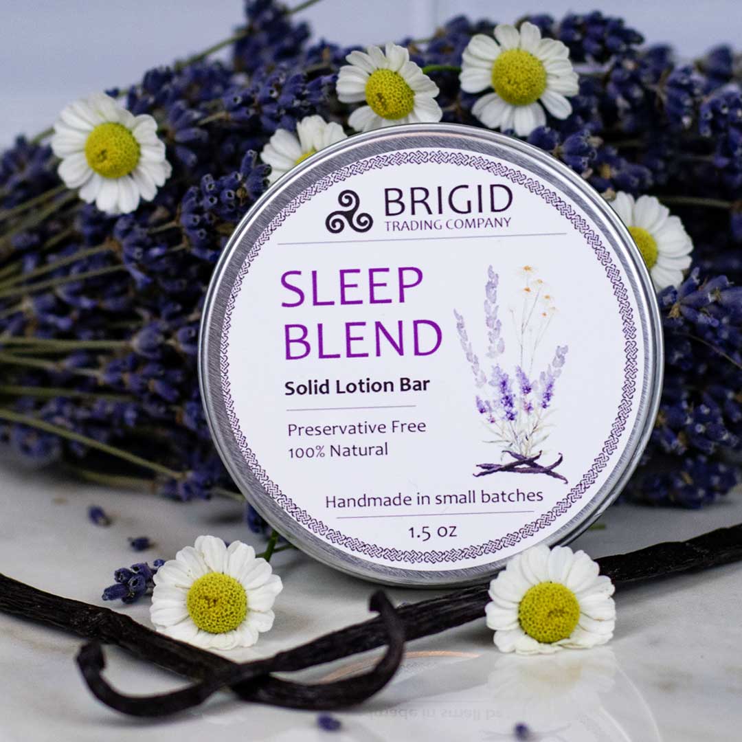 sleep blend solid lotion bar preservative free by brigid trading company lavender chamomile vanilla in background props made with essential oils only no irritants sensitive skin natural skincare